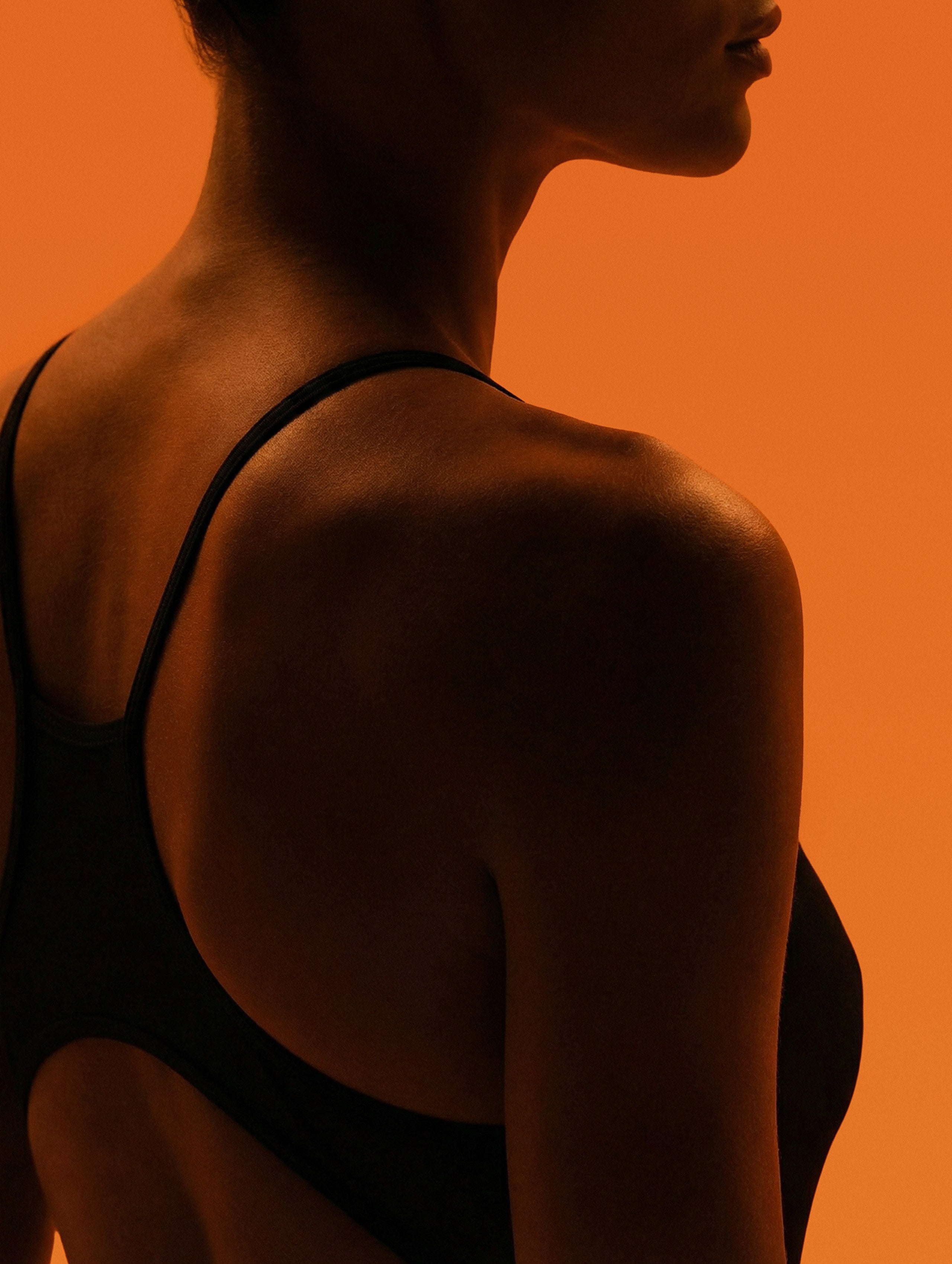 Backlit shoulder against warm amber light