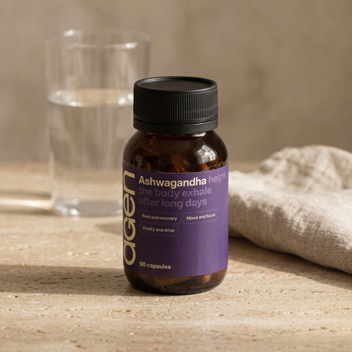 Agen Ashwagandha bottle on a travertine counter in soft morning light