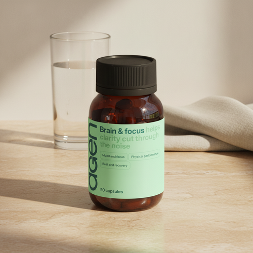 Agen Brain & Focus bottle on a travertine counter in soft morning light