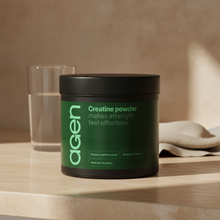 Agen Creatine Powder tub on a travertine counter in soft morning light
