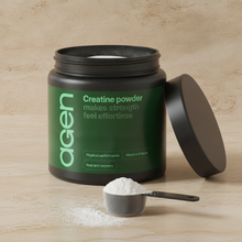 Agen Creatine Powder — open tub with a scoop of powder on a stone counter