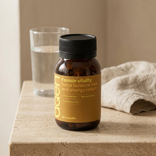 Agen Female Vitality bottle on a travertine counter in soft morning light