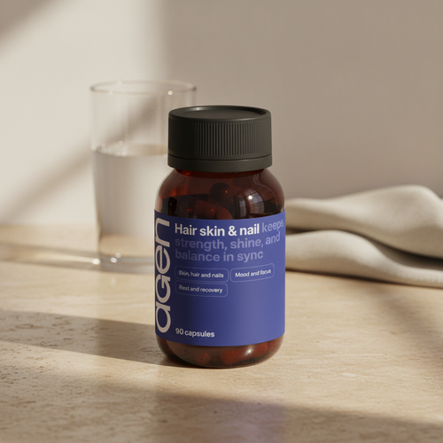 Agen Hair, Skin & Nail bottle on a travertine counter in soft morning light