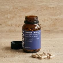 Agen Hair, Skin & Nail — open bottle with capsules on a stone counter