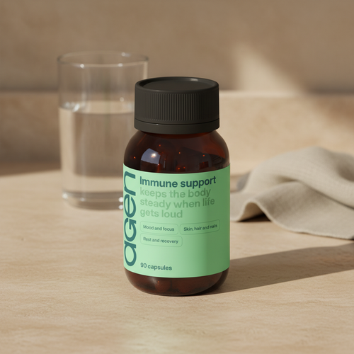 Agen Immune Support bottle on a travertine counter in soft morning light