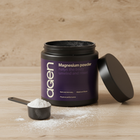 Agen Magnesium Powder — open tub with a scoop of powder on a stone counter