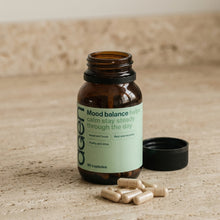 Agen Mood Balance — open bottle with capsules on a stone counter