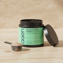 Agen Mushroom Focus Powder — open tub with a scoop of powder on a stone counter