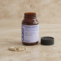 Agen Probiotic Balance — open bottle with capsules on a stone counter