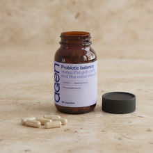 Agen Probiotic Balance — open bottle with capsules on a stone counter