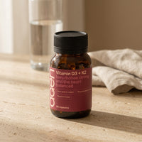 Agen Vitamin D3 + K2 bottle on a travertine counter in soft morning light