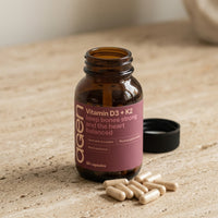 Agen Vitamin D3 + K2 — open bottle with capsules on a stone counter